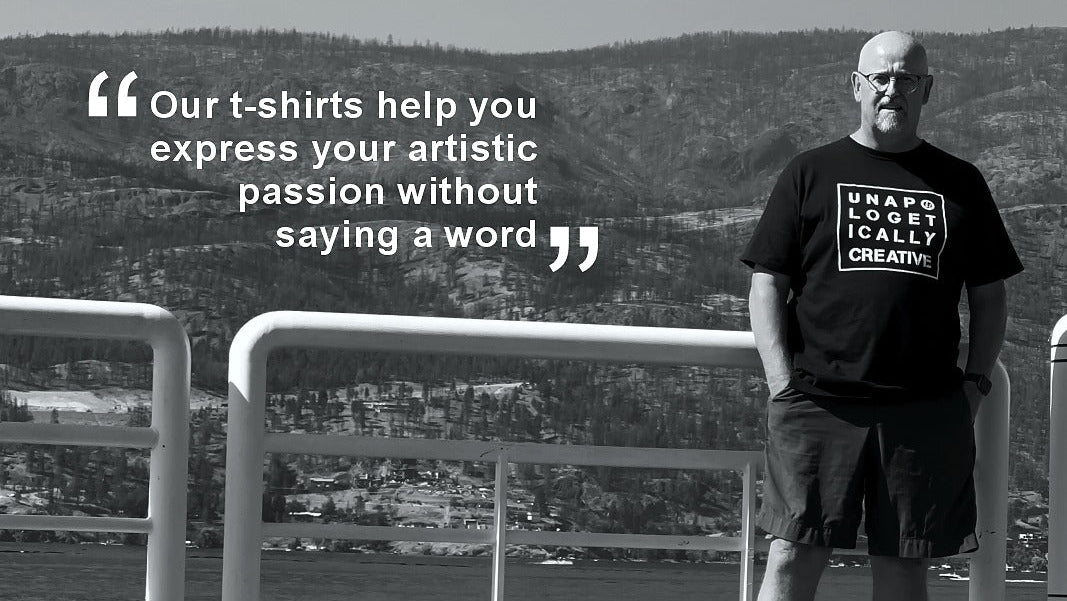 Man wearing a t-shirt with text standing on a dock with scenic background